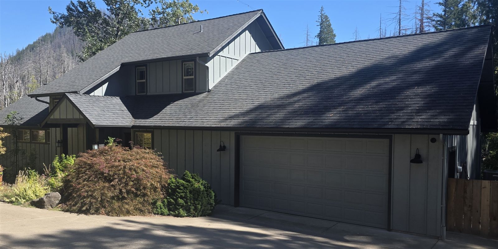Front exterior and two-car garage of The River Front House at Vida View Retreat
