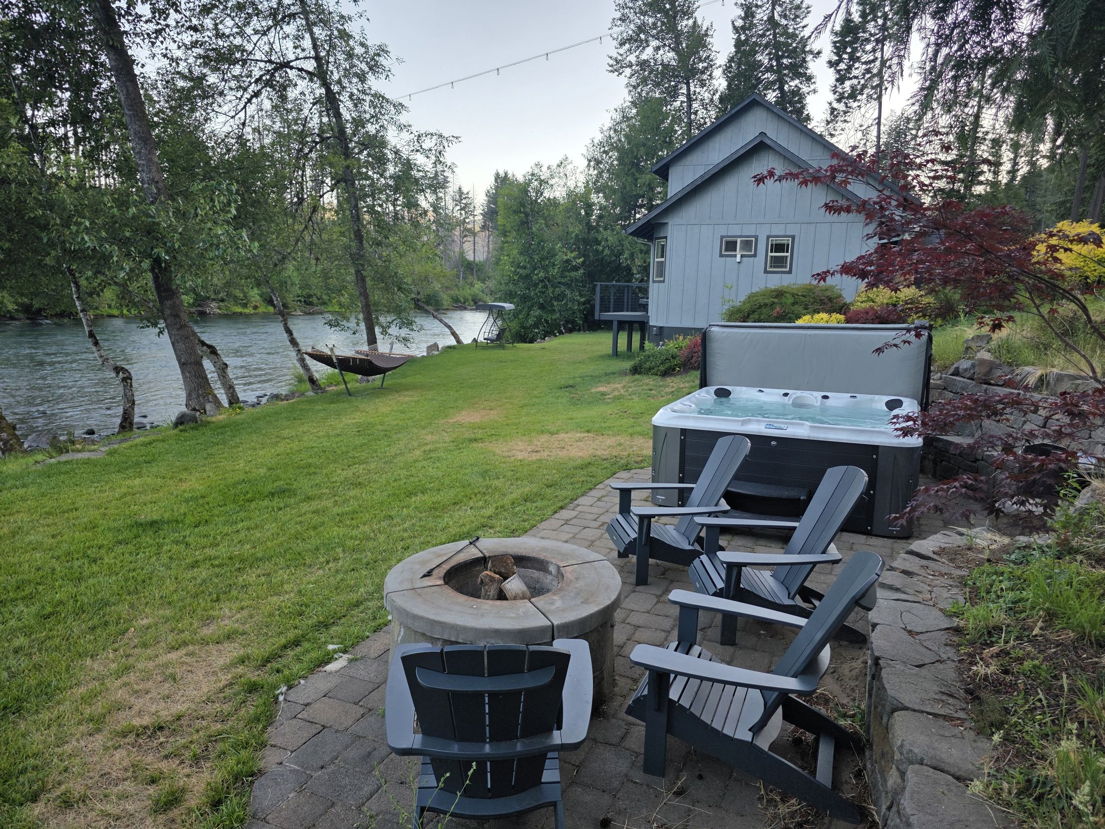 Hot tub and riverside lawn at The River Front House