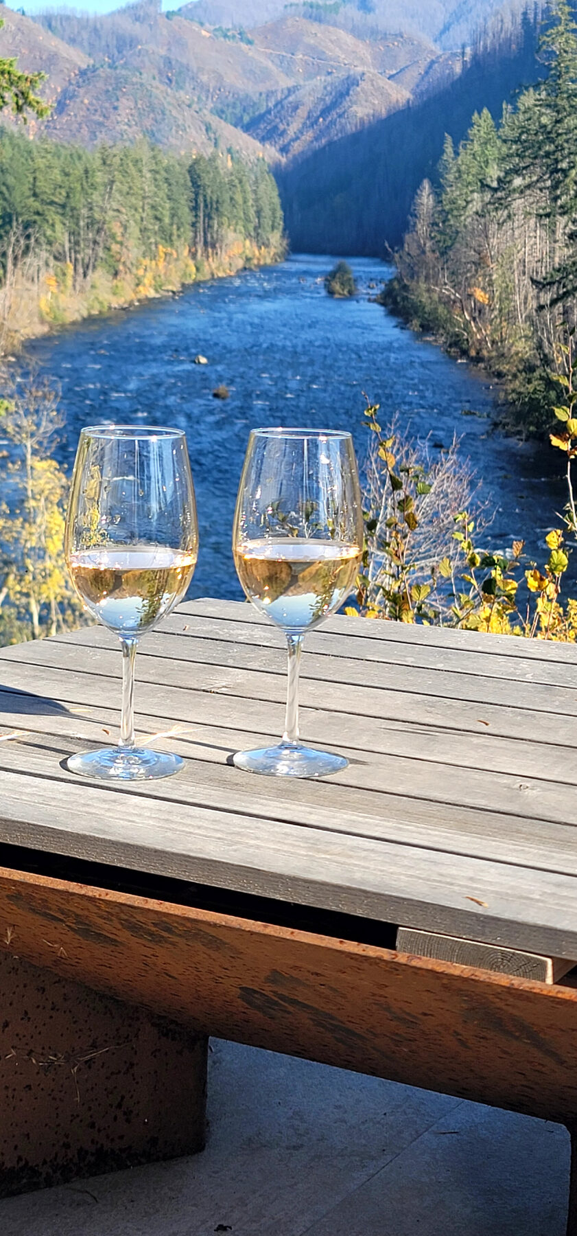 Two glasses of wine overlooking the autumn McKenzie River